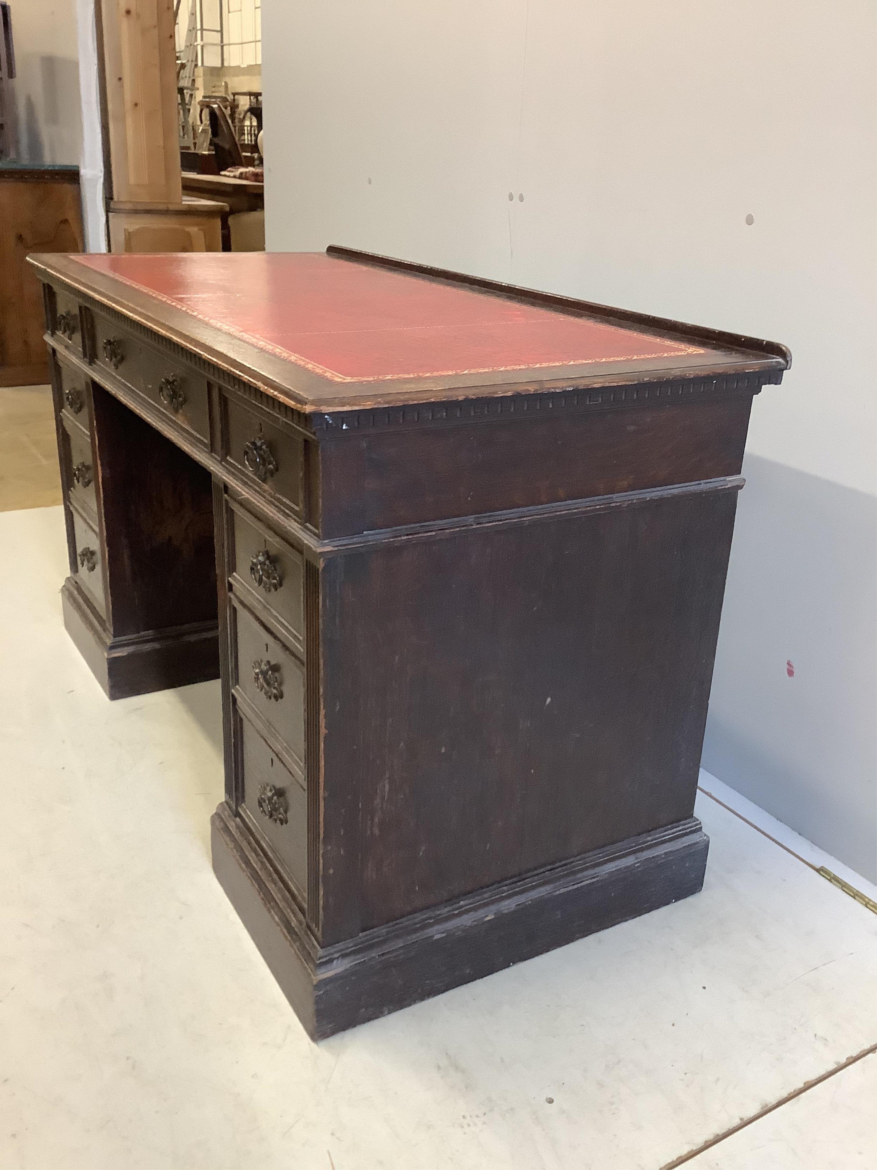 A late Victorian oak pedestal desk, width 128cm, depth 61cm, height 77cm. Condition - fair